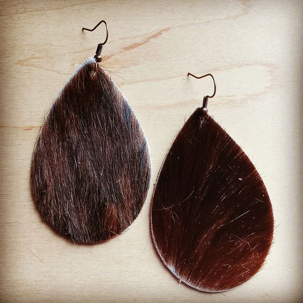 Leather teardrop earrings in brown hair on hide