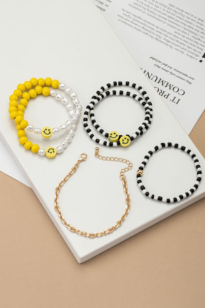 6 beaded bracelets set with polymer smiley face
